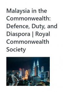 Night time cityscape of Kuala Lumpur with the Petronas Twin Towers illuminated.