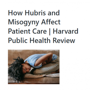 Person curled up on a sofa holding their stomach, appearing to be in pain.