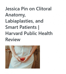 Person in a light dress holding a red flower at their waist.